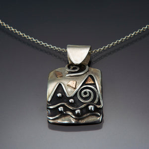 silver pendant mountain and water scene, black patina with spirals and 14k gold fill accents on a silver bale and chain