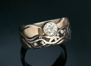 14k white gold ring with diamond, yellow gold surrounding a wave pattern with black patina 