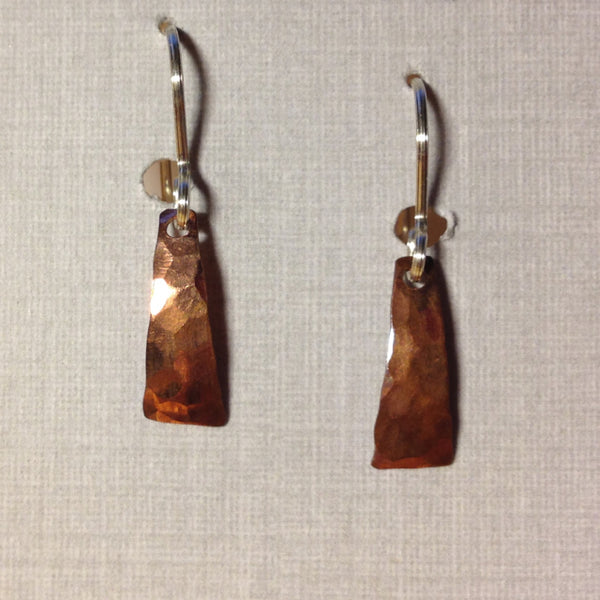 Small shiny hammered copper earrings in a triangular shape