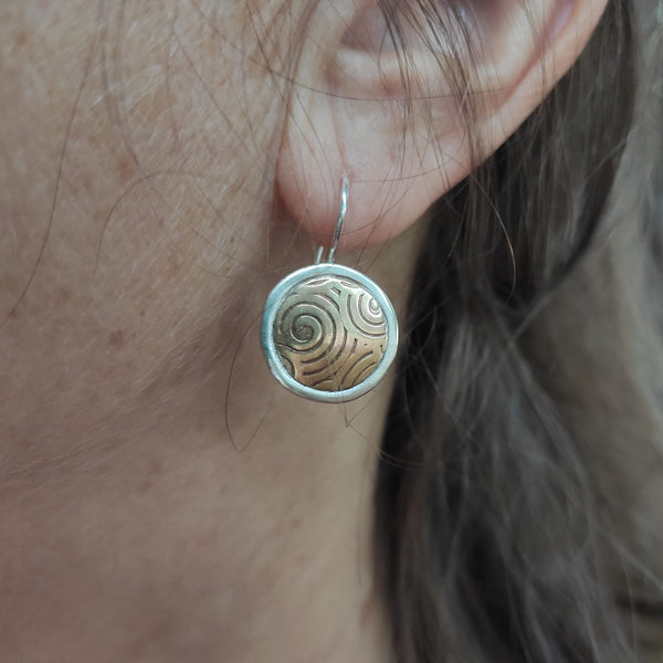 round silver earrings with inlayed gold brass embossed with spirals