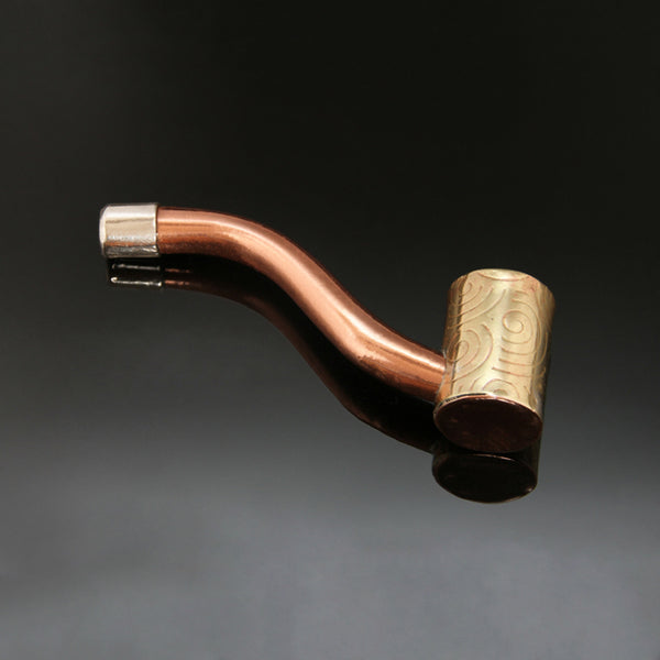 Traditionally shaped pipe with a narrow straight brass bowl embossed with spirals and a silver mouthpiece at the end of a copper stem.