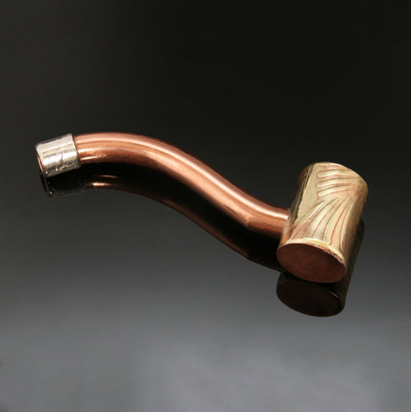 Traditionally shaped pipe with a narrow straight brass bowl embossed with a bamboo pattern and a silver mouthpiece at the end of a copper stem.