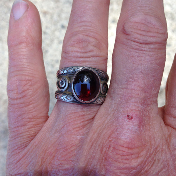 double band silver ring with oval garnet with recessed parts oxidized.