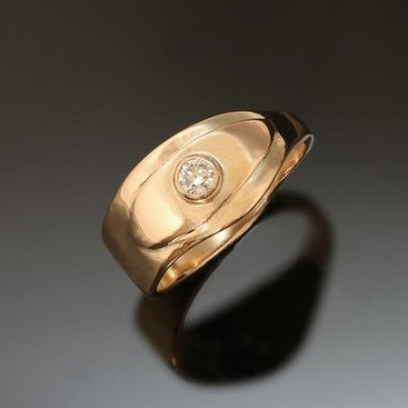 14k yellow gold ring with wavy edges and small diamond, raised gold around the diamond.