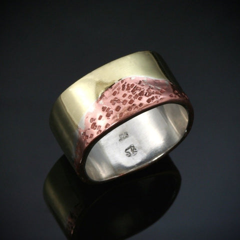 wide silver ring with a layer of shiny gold brass and hammered copper