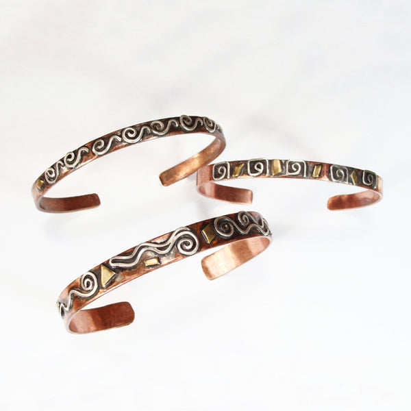 3 copper bracelets with different silver patterns. Squares, spirals, waves with brass and black patina.