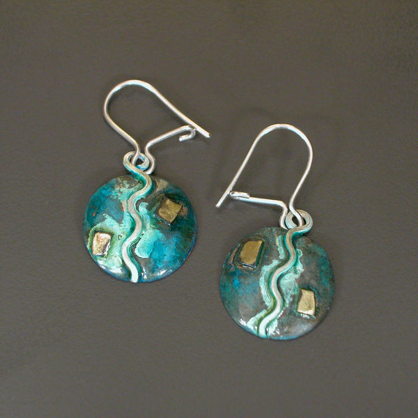 round copper earrings with vertical silver and blue patina