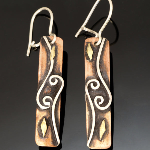 long rectangular copper earrings with 2 spirals and waves, brass accents and black patina.