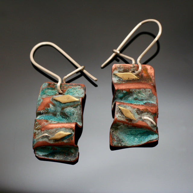 small folded copper earrings with silver and brass accents and antiqued patina