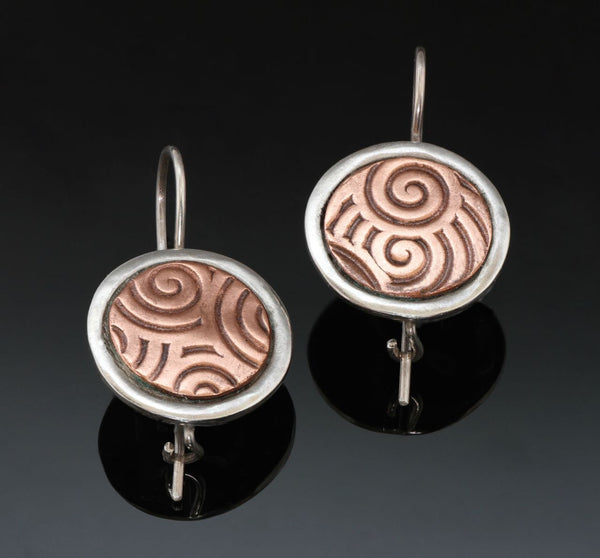 round silver earrings with inlayed copper embossed with spirals