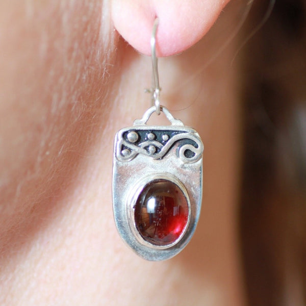 silver earrings with patina and oval garnet