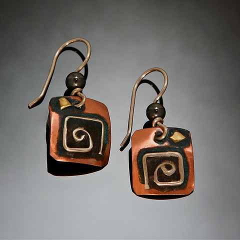 square silver spiral on copper earrings with black patina and hematite bead