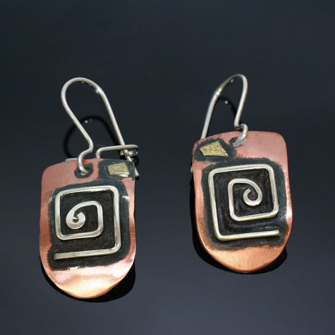 half round copper earrings with square silver spirals and brass accent black patina.