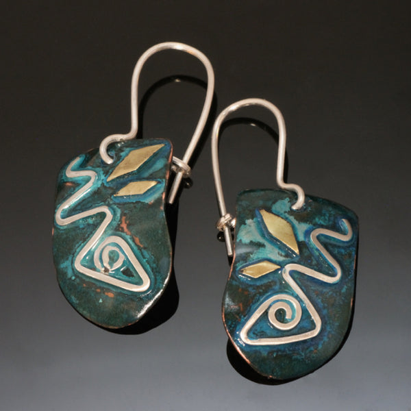 Larger copper earrings with a silver fish design, brass and blue-green patina