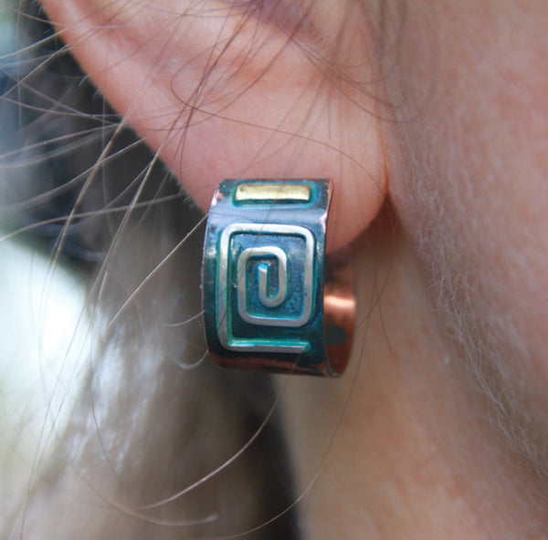 copper studs in hoop shape with square silver spiral, brass and blue patina