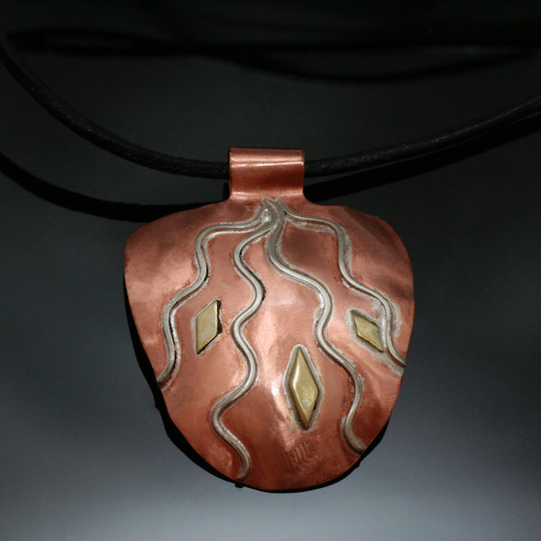 half round natural copper pendant with silver rays streaming down and brass accents
