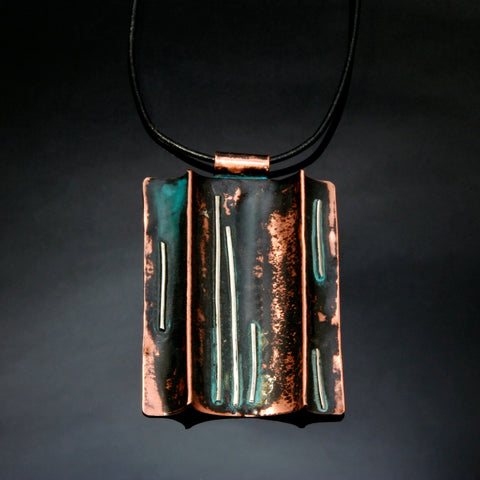 folded copper necklace with patina, straight lines of silver on a leather band