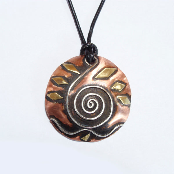 round copper necklace with black patina, silver wave and spiral shaped like a clavicle, brass accents on a leather band