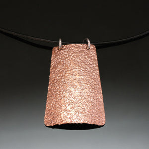 hammered copper necklace with silver loops on a leather band