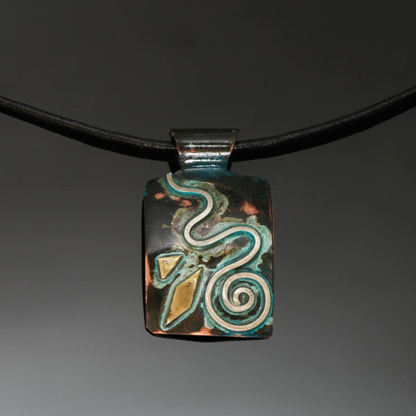 rectangular copper necklace with silver spiral, brass and green patina on a leather band