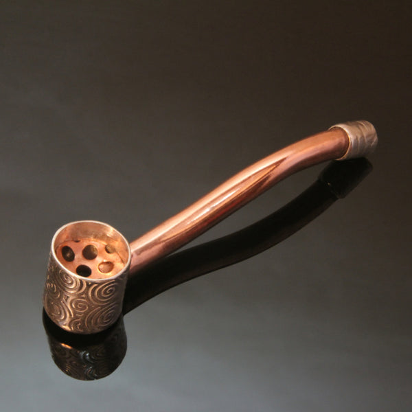 small copper pipe with a silver bowl and a copper screen inside the bowl