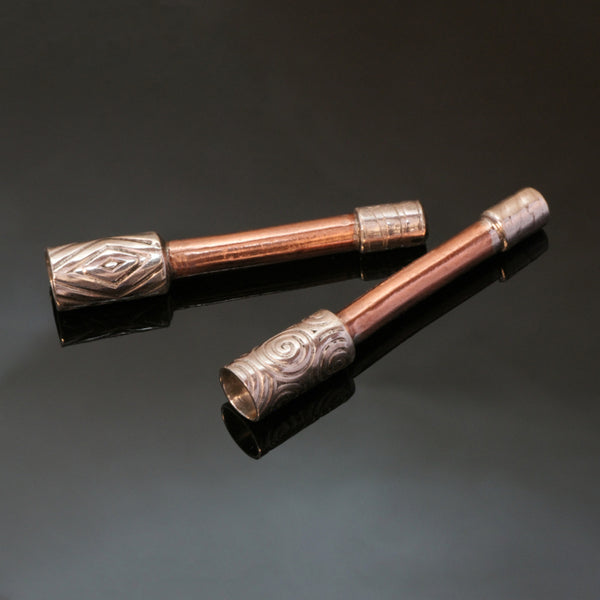 Two small straight pipes with copper stem and patterned silver bowls.