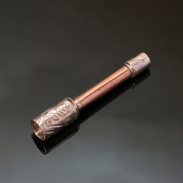 small straight pipe with copper stem and silver bowl embossed with spirals.