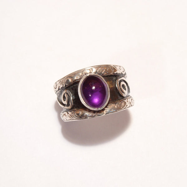 double band silver ring with oval amethyst with recessed parts oxidized.