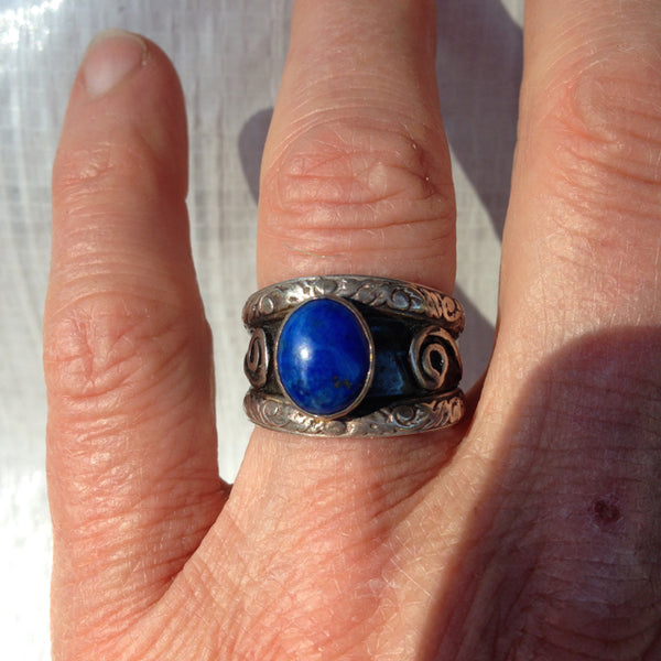double band silver ring with oval blue lapis lazuli with recessed parts oxidized.