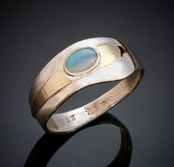 14k yellow gold ring with wavy edges, raised gold around the oval blue and green opal.