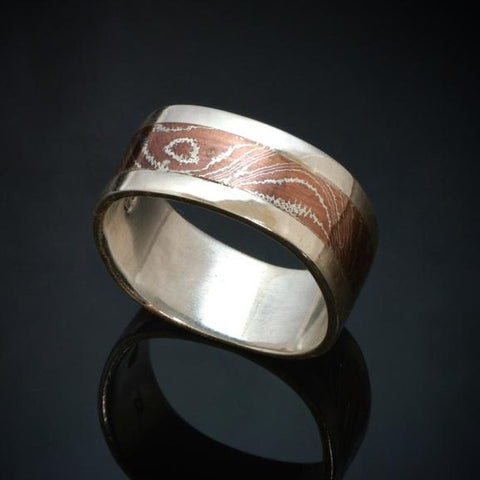 9mm wide Silver band with a centre band of mokume gane. The mokume has a wood grain pattern and is made with copper and silver.