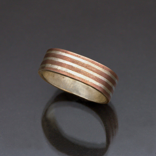 Narrow Silver band with long stripes of silver and copper with a brushed finish. 
