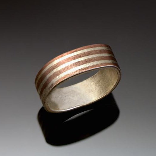 Narrow Silver band with long stripes of silver and copper with a brushed finish. 