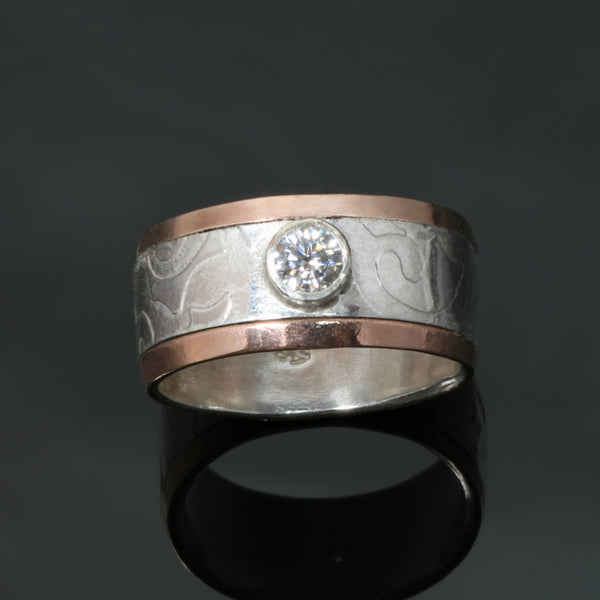 silver ring with doily pattern, gold rails and cubic zirconia