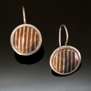 round silver earrings with striped copper silver inlays