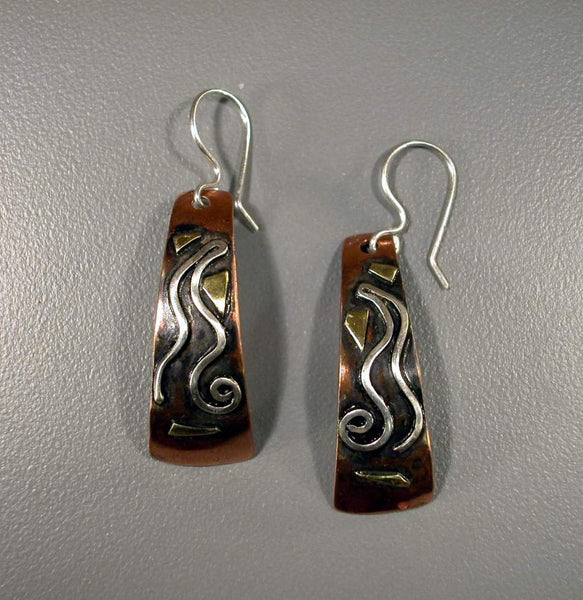 long copper earrings with a silver spiral wave, brass and black patina
