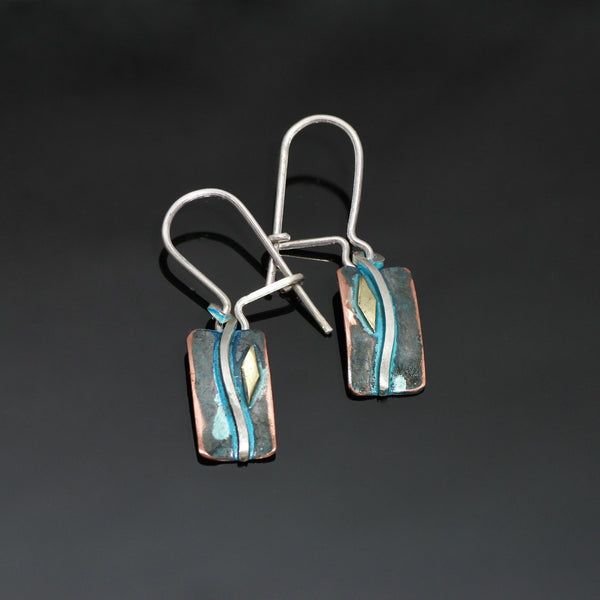 small rectangular copper earrings with a silver wave, brass and blue patina