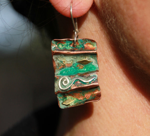 fold formed copper earrings with spiral and brass accents oxidized blue green