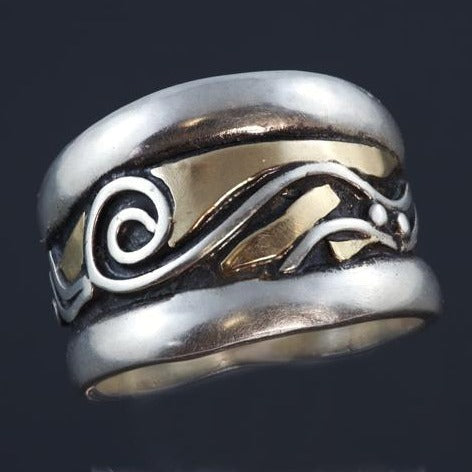 Wide silver band with raised rounded edges, gold, spirals and wave pattern in the centre with recessed parts oxidized.